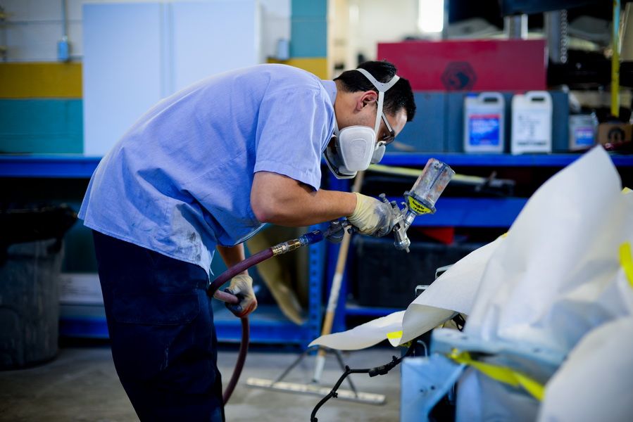 Technician Sanding Car Bumper For Refinish | D&V Autobody