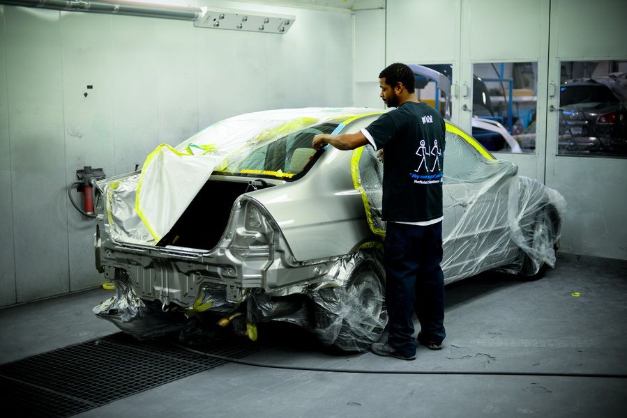 Car Covered In Plastic Inside Paint Booth | D&V Autobody