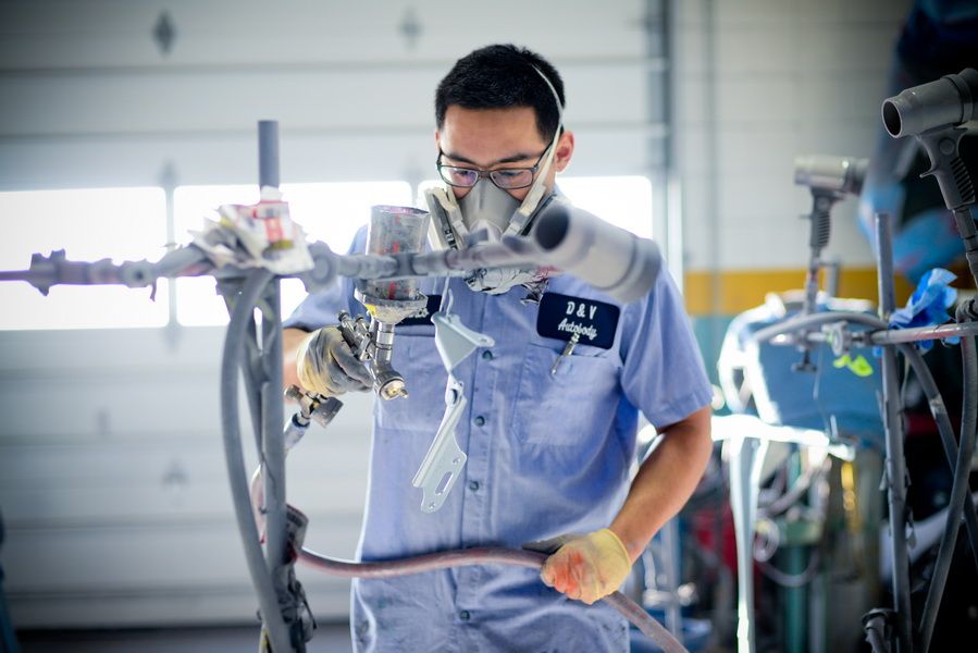 Technician Using Tool To Repair Car Part | D&V Autobody