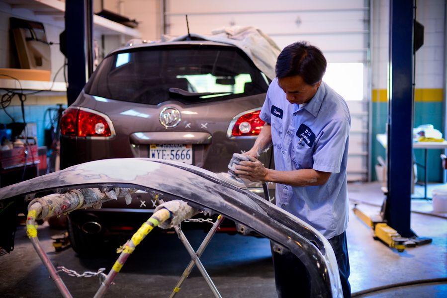 Mechanic Repairing Front Bumper Of Silver Car | D&V Autobody
