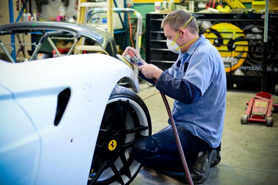 Technician Repairing White Car Hood | D&V Autobody