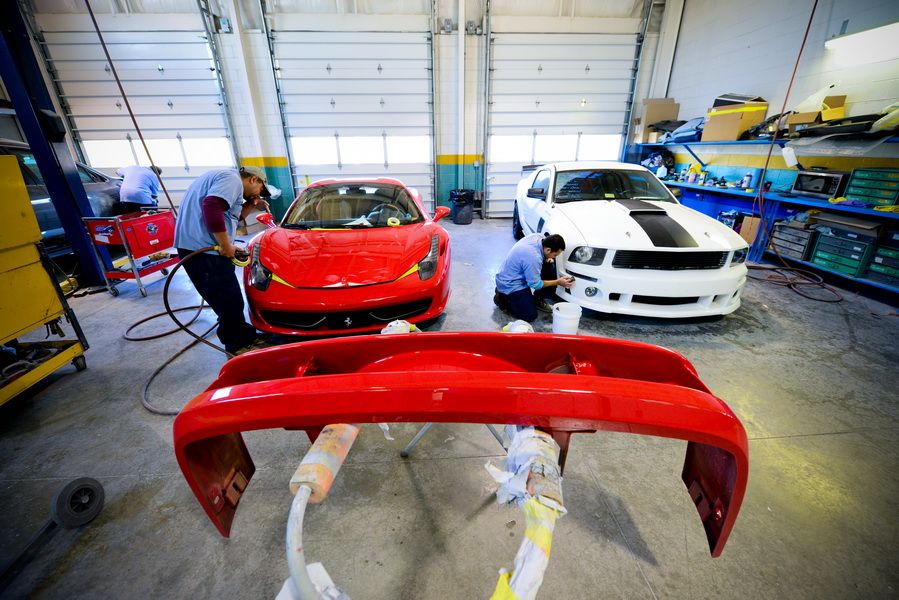 Red Car And Painted Bumper Inside Auto Shop | D&V Autobody