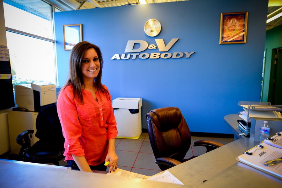 Friendly Receptionist Smiling At Front Desk | D&V Autobody