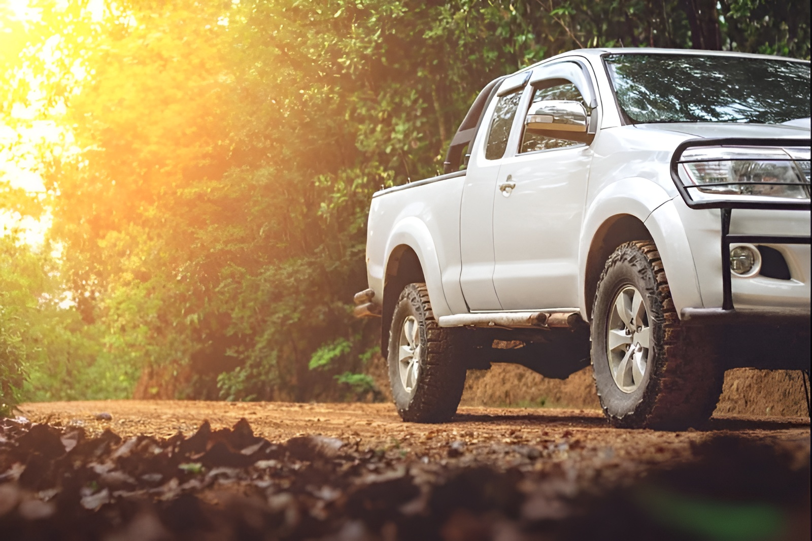 Silver Pickup Truck on a Dirt Road, Trees in the Background, Bright Sunlight — Allquip Rentals Pty Ltd in Cooroy, QLD