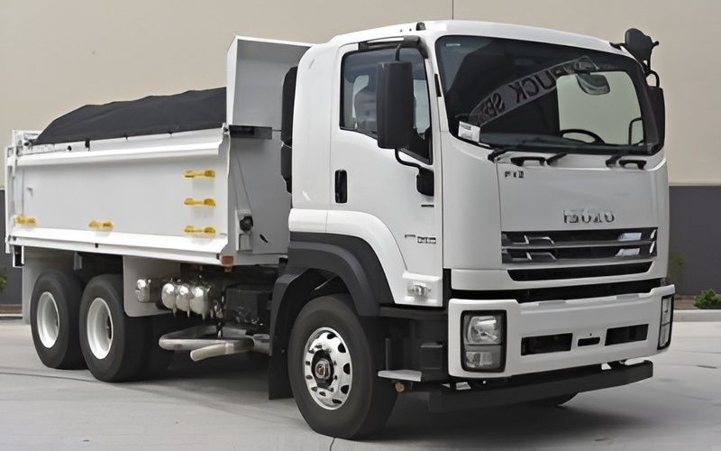 White Isuzu Dump Truck Parked, Bed Filled With Dark Material — Allquip Rentals Pty Ltd in Cooroy, QLD