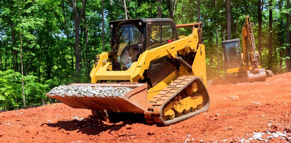 Yellow Skid Steer Loader With Gravel Bucket — Allquip Rentals Pty Ltd in Cooroy, QLD
