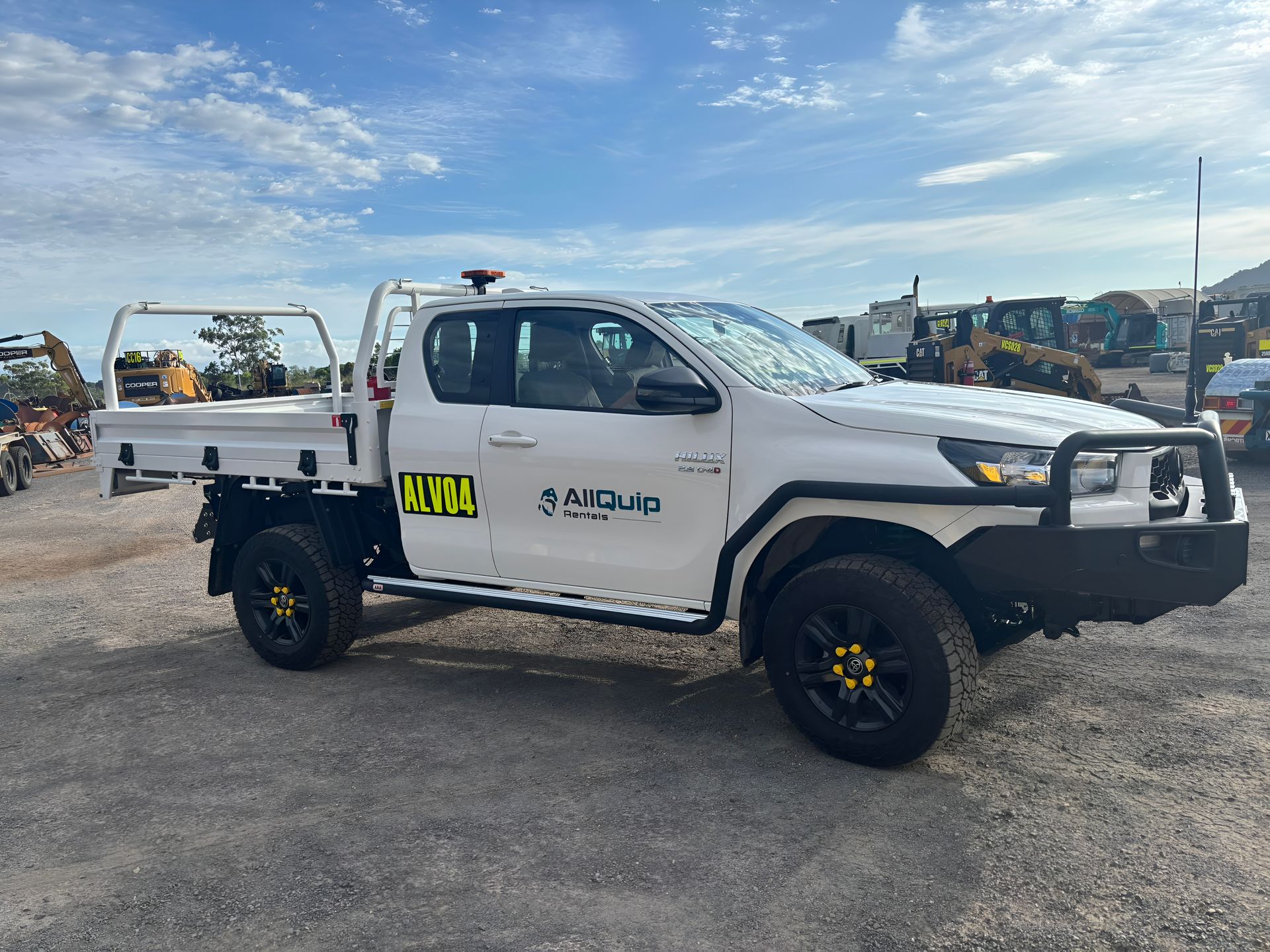 White Toyota Hilux Utility Truck With Black Bullbar and Wheels Parked Outdoors — Allquip Rentals Pty Ltd in Cooroy, QLD