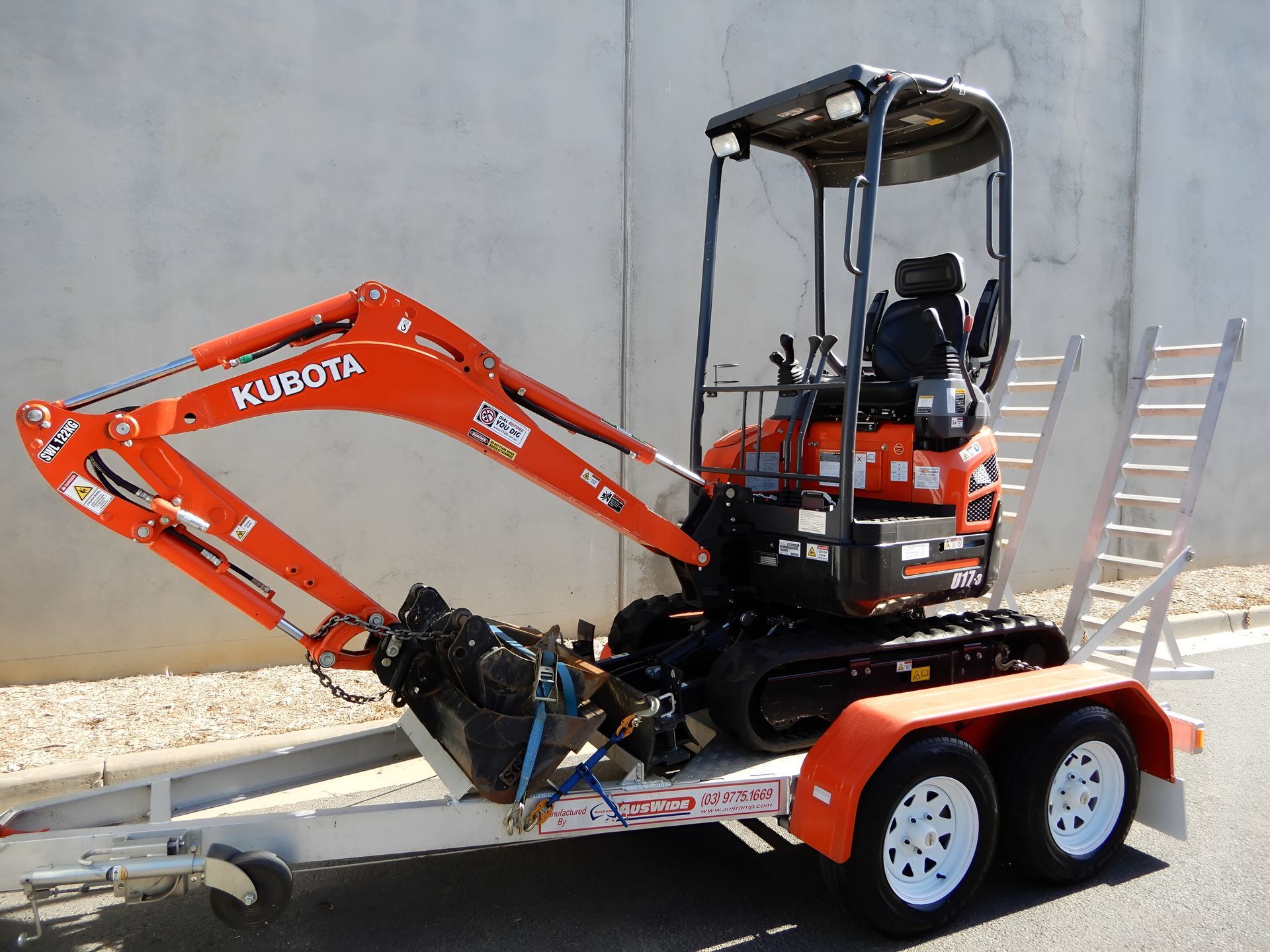 Orange Kubota Excavator on a Trailer With a White Ramp — Allquip Rentals Pty Ltd in Cooroy, QLD