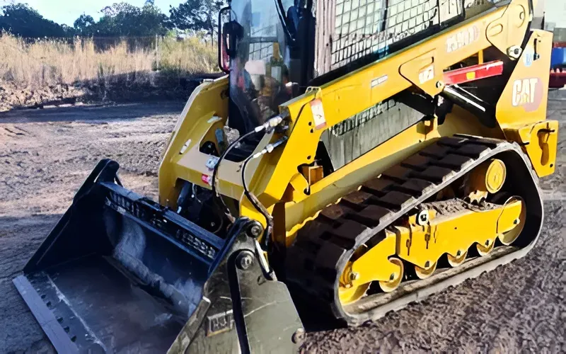 Yellow Caterpillar Track Skid Steer Loader With Bucket on Dirt — Allquip Rentals Pty Ltd in Cooroy, QLD