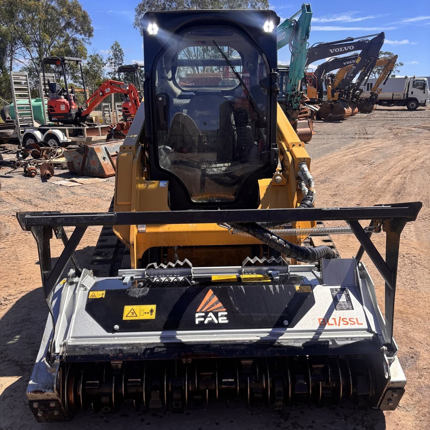 Yellow Black Skid Steer Loader Resting