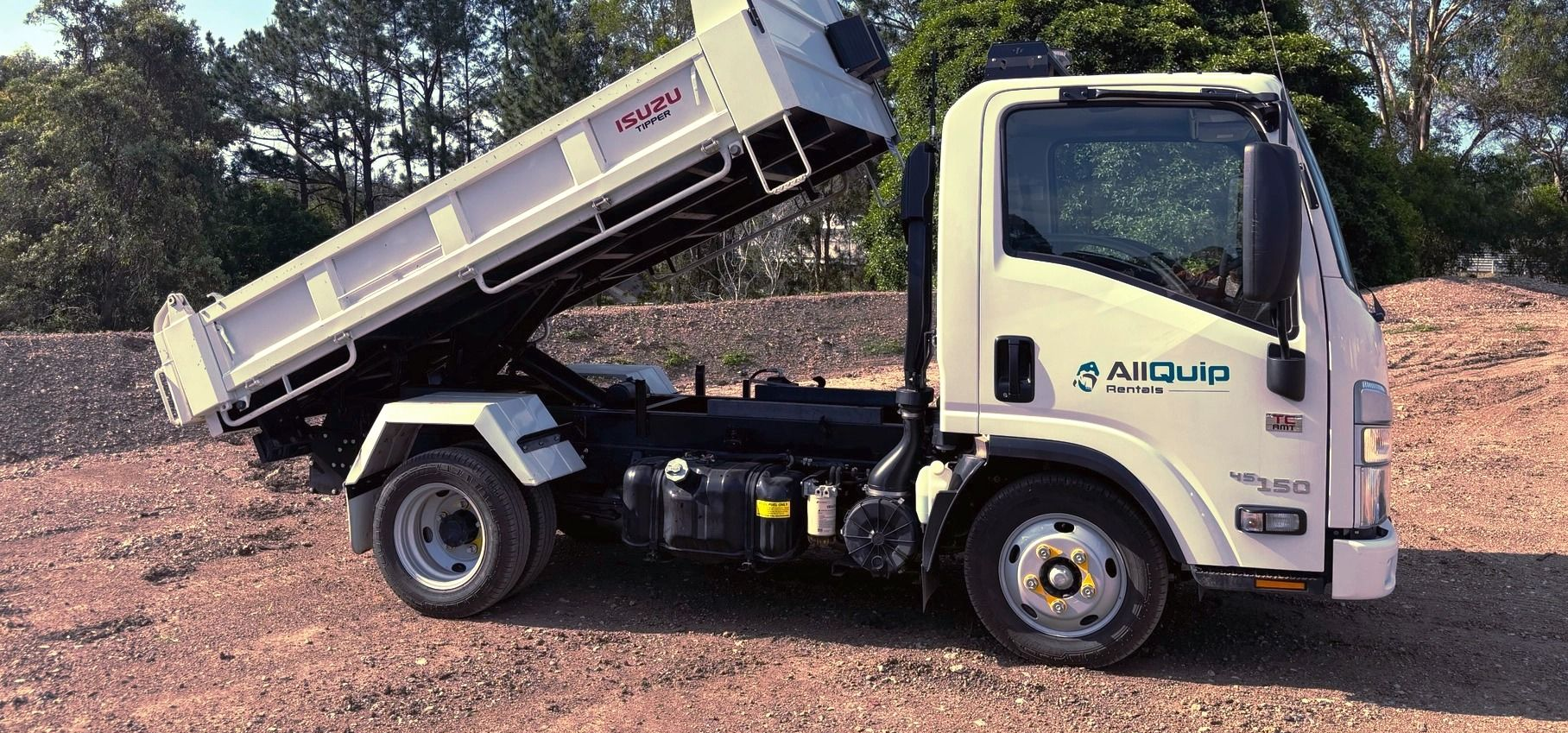 White Dump Truck With Raised Bed on a Gravel Track — Allquip Rentals Pty Ltd in Cooroy, QLD
