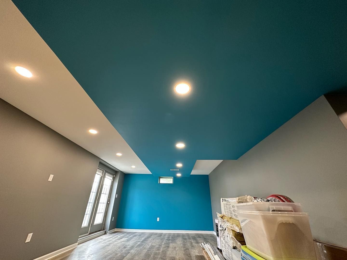 A living room with blue walls and a blue ceiling.