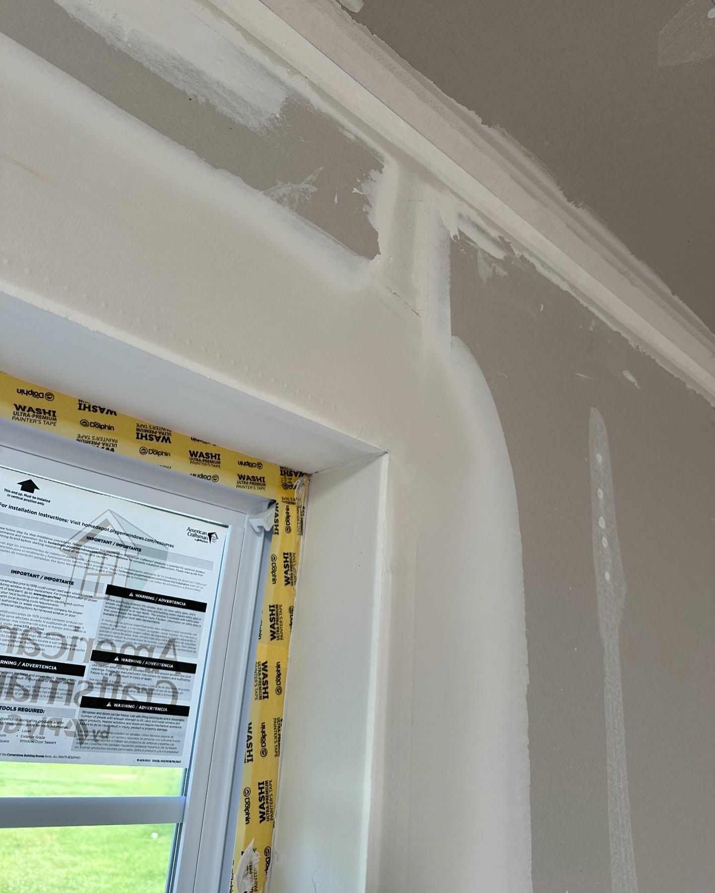 A window in a room that is being painted white