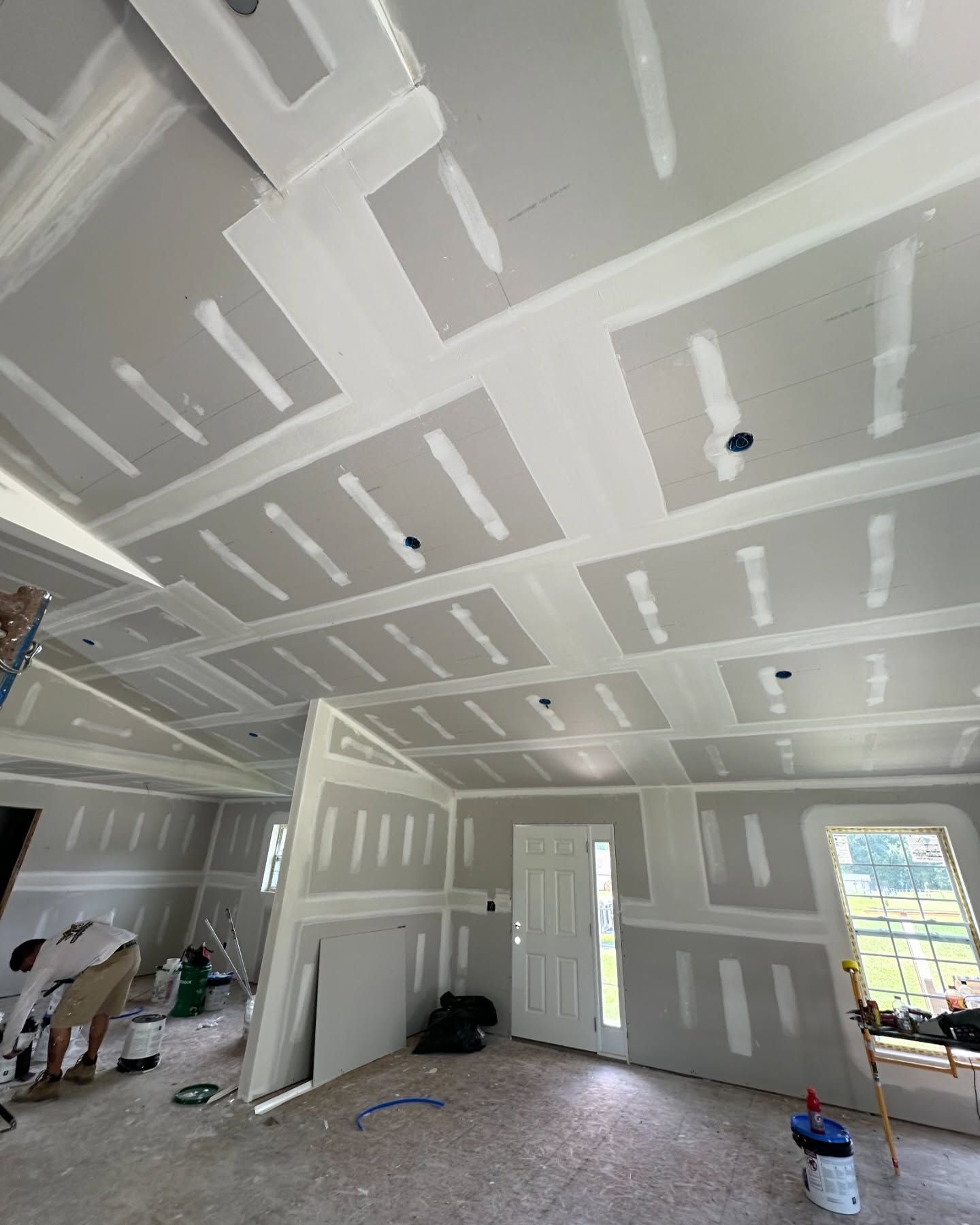 A room with a lot of drywall on the ceiling and walls.