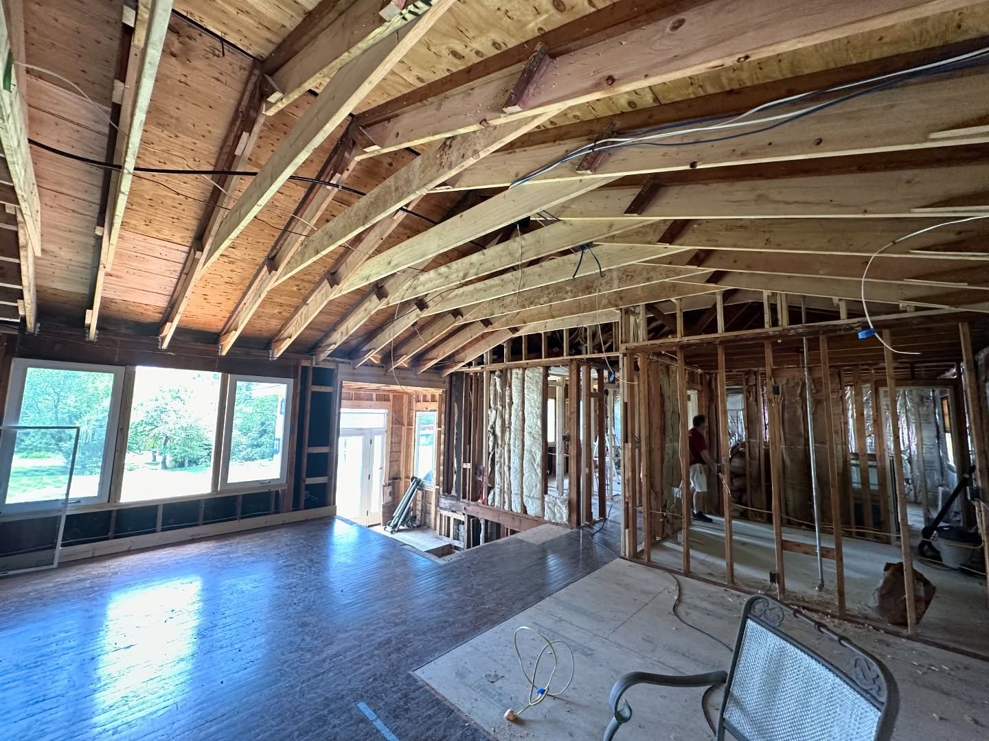 The inside of a house under construction with wooden beams.
