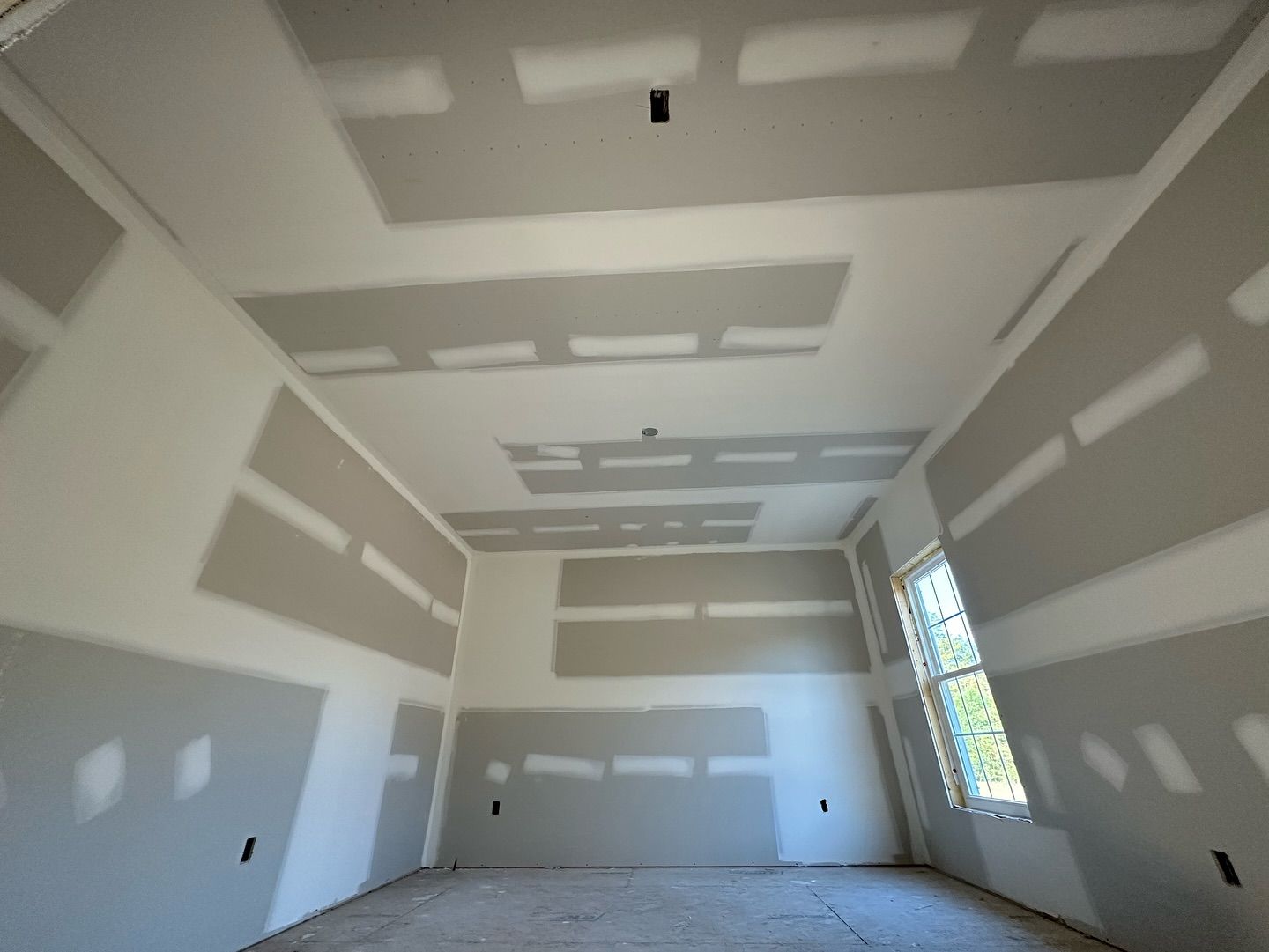 A room that is being remodeled with drywall on the walls