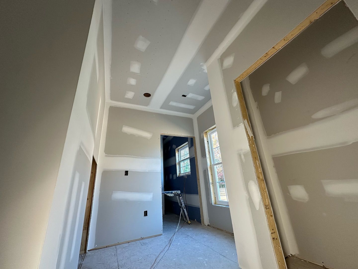 A room with drywall on the walls and ceiling