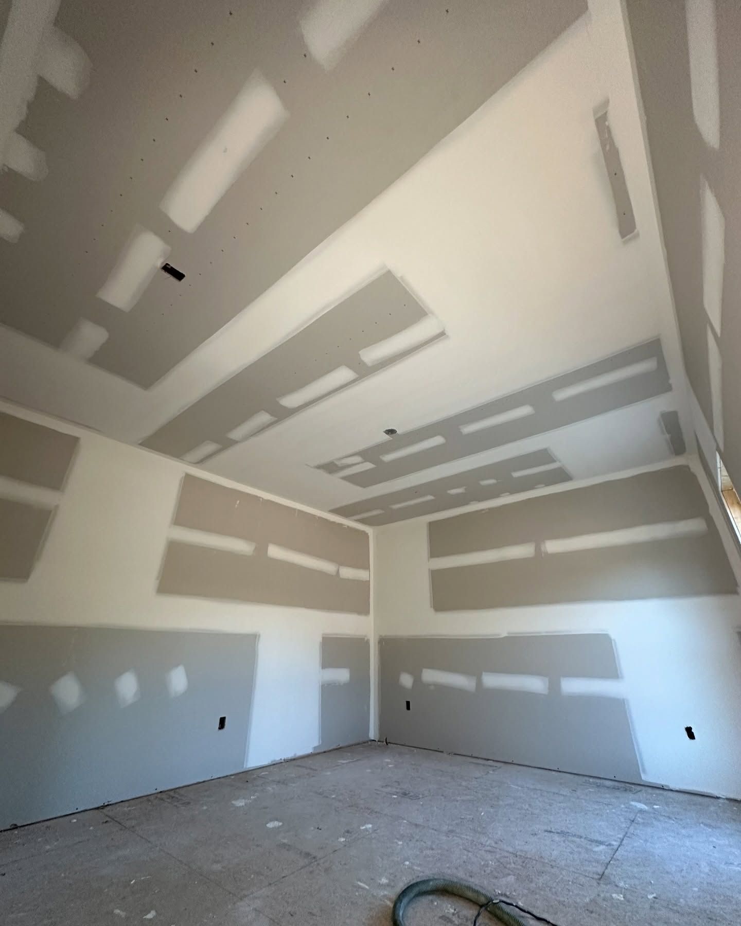 An empty room with a vacuum hose in it