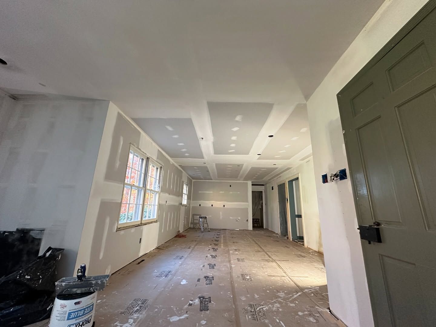 A large room with a ceiling that is being remodeled.