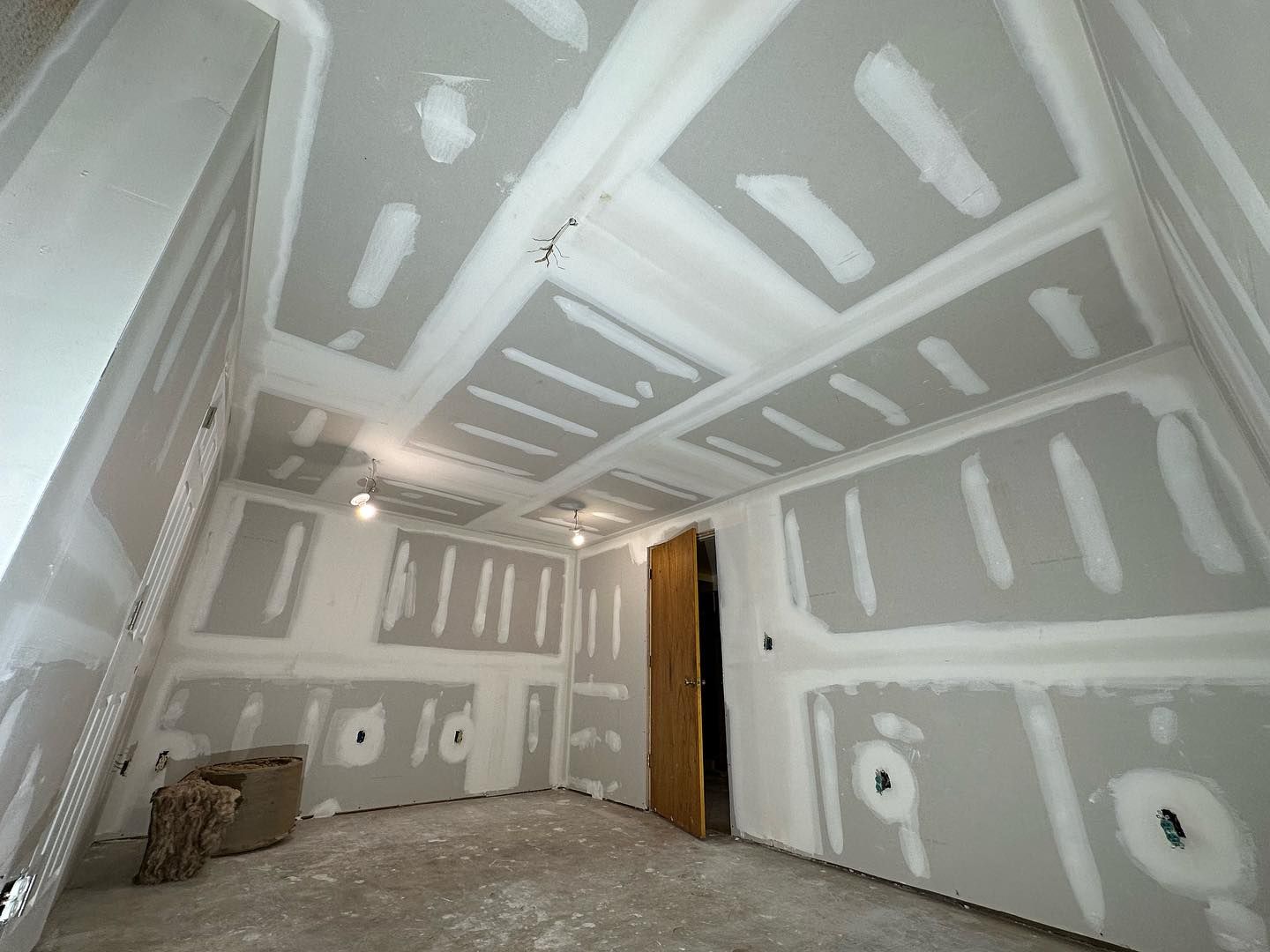 A room with a lot of drywall on the walls and ceiling.