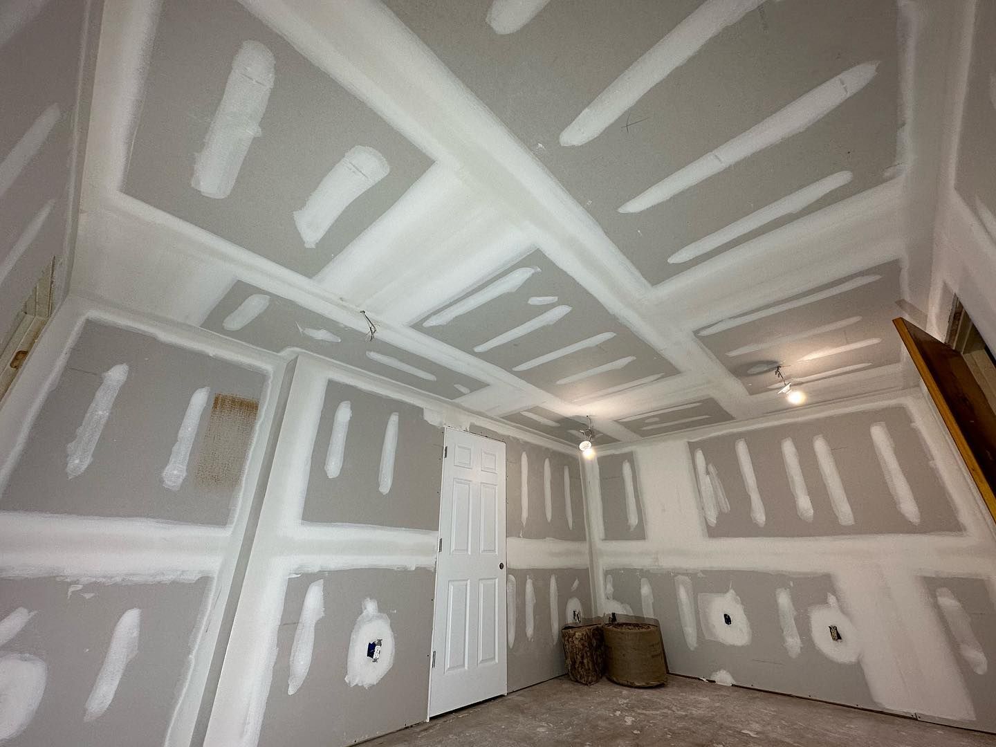 A room with a lot of drywall on the walls and ceiling