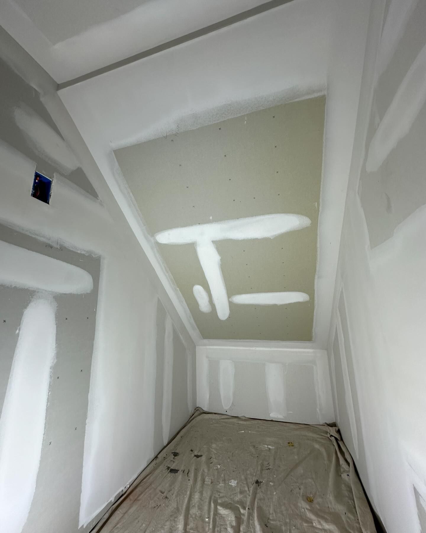 A room with a ceiling that has the letter t on it.