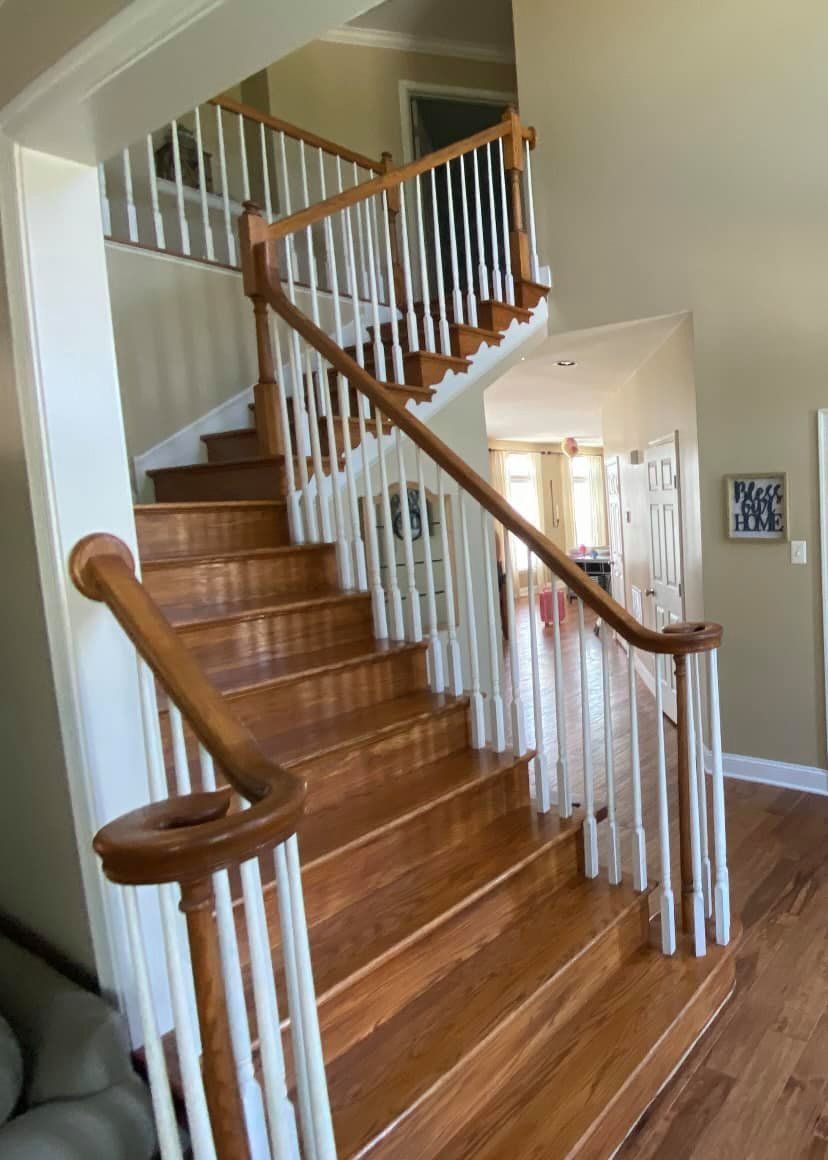 A wooden staircase with white railings in a house