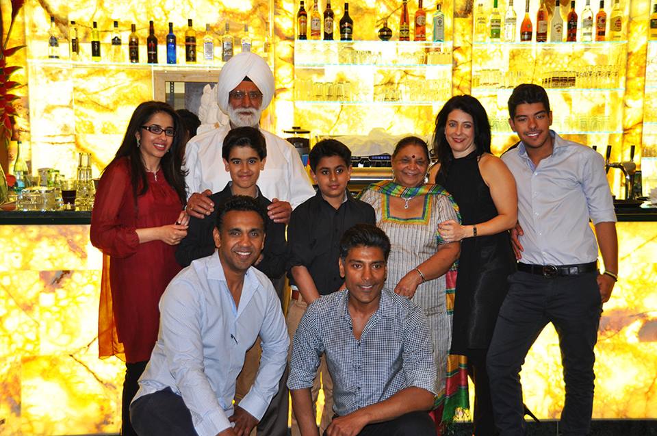 Eine Gruppe von Menschen posiert für ein Foto vor einer Bar