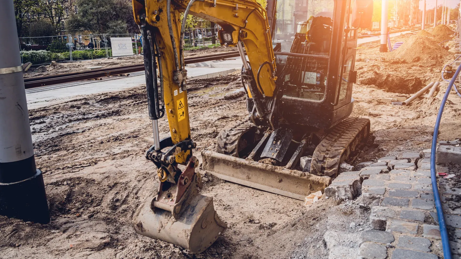 Mini excavator operating at a narrow urban construction site