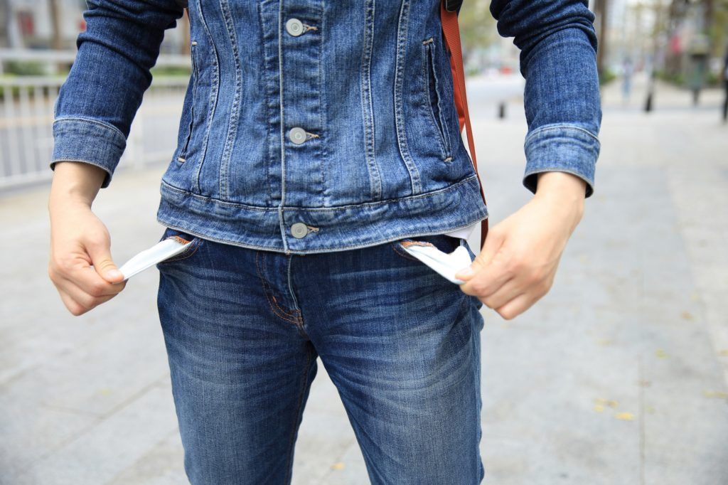 A person wearing a denim jacket and jeans has their pockets empty. A person wearing a denim jacket and jeans has their pockets empty.