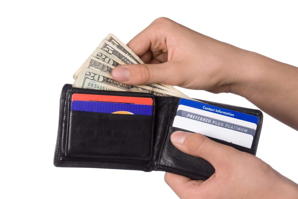 A person is taking money out of their wallet