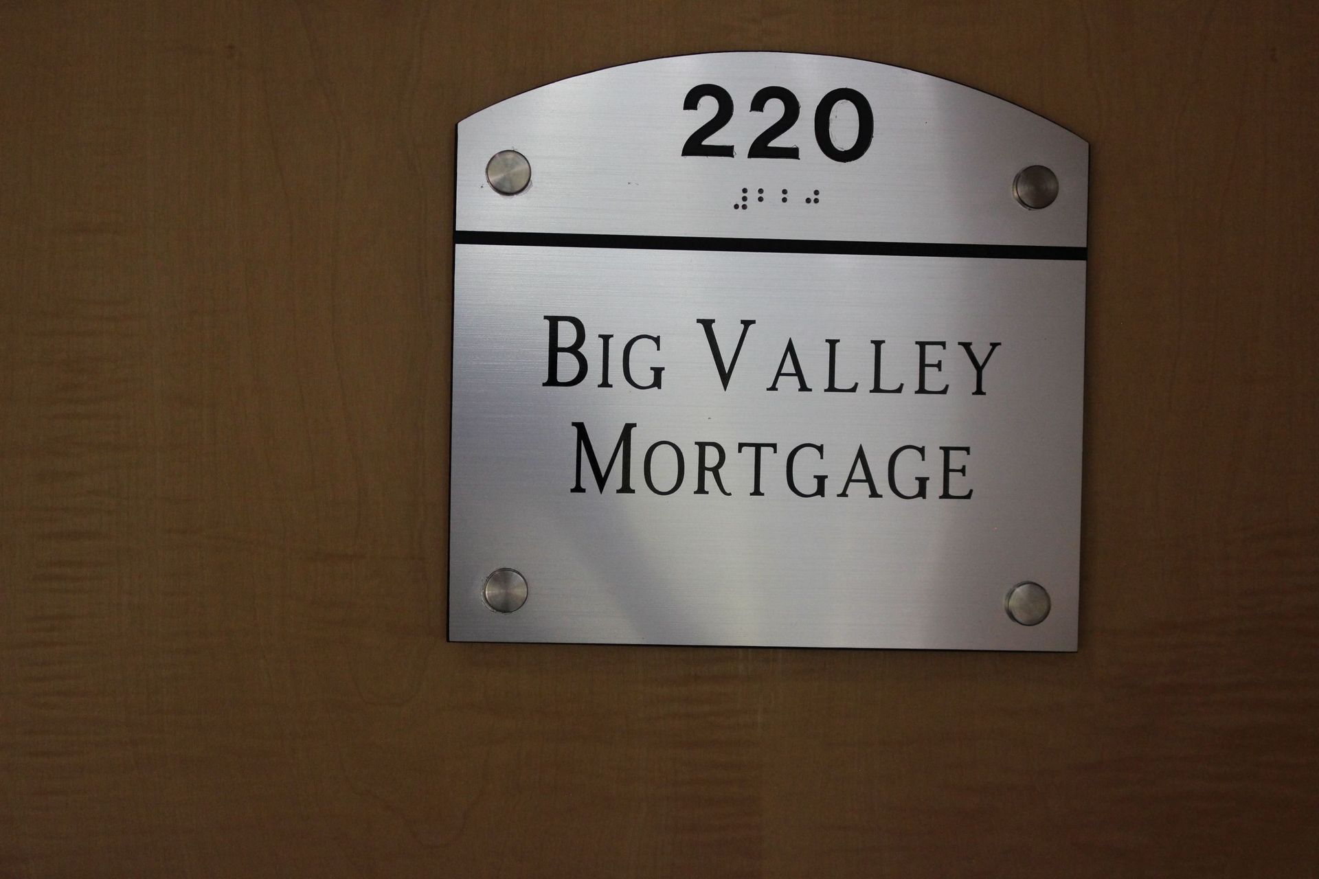 A silver office sign with the number