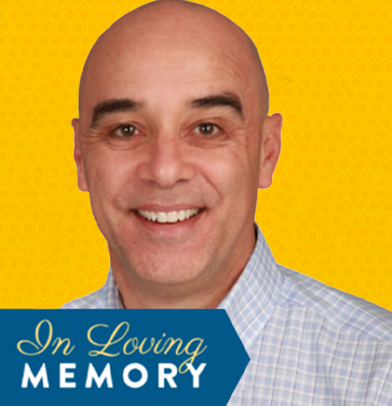 Andrew Vierra smiling in a light blue shirt with