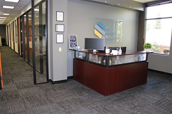 A reception area in a mortgage company in Roseville, CA, with a desk and a computer.