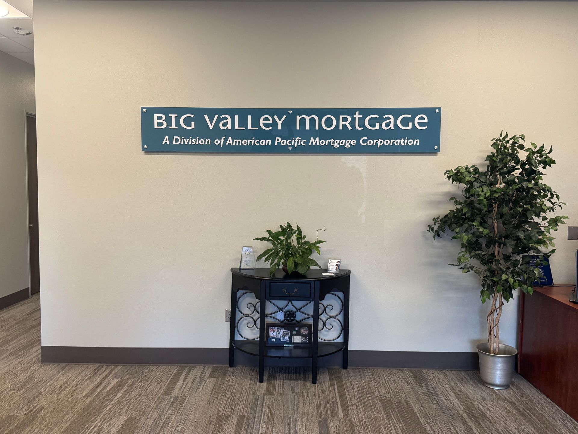 There is a sign on the wall of a mortgage company in Roseville, CA, that says Big Valley Mortgage.