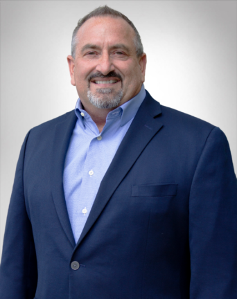 James Wagner in a blue suit and blue shirt is smiling | Mortgage Lender in Roseville, CA