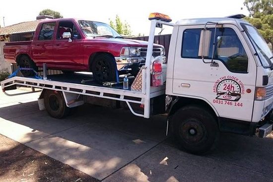 tow truck towing red truck