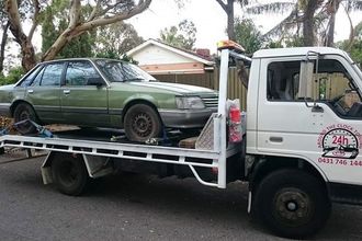 tow truck towing green car