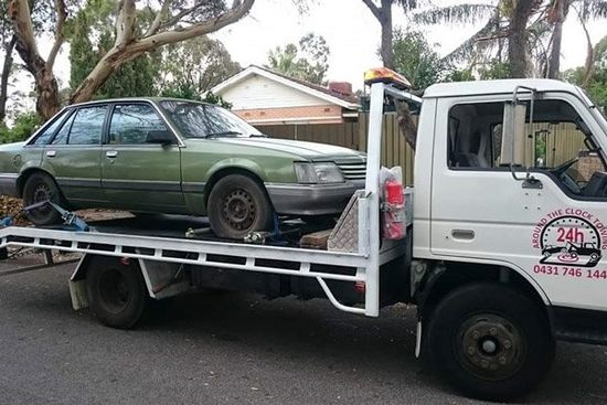 tow truck towing green car