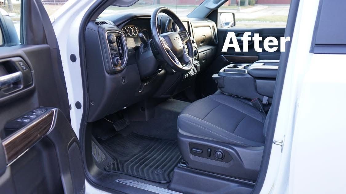 The interior of a white truck is shown after being cleaned.