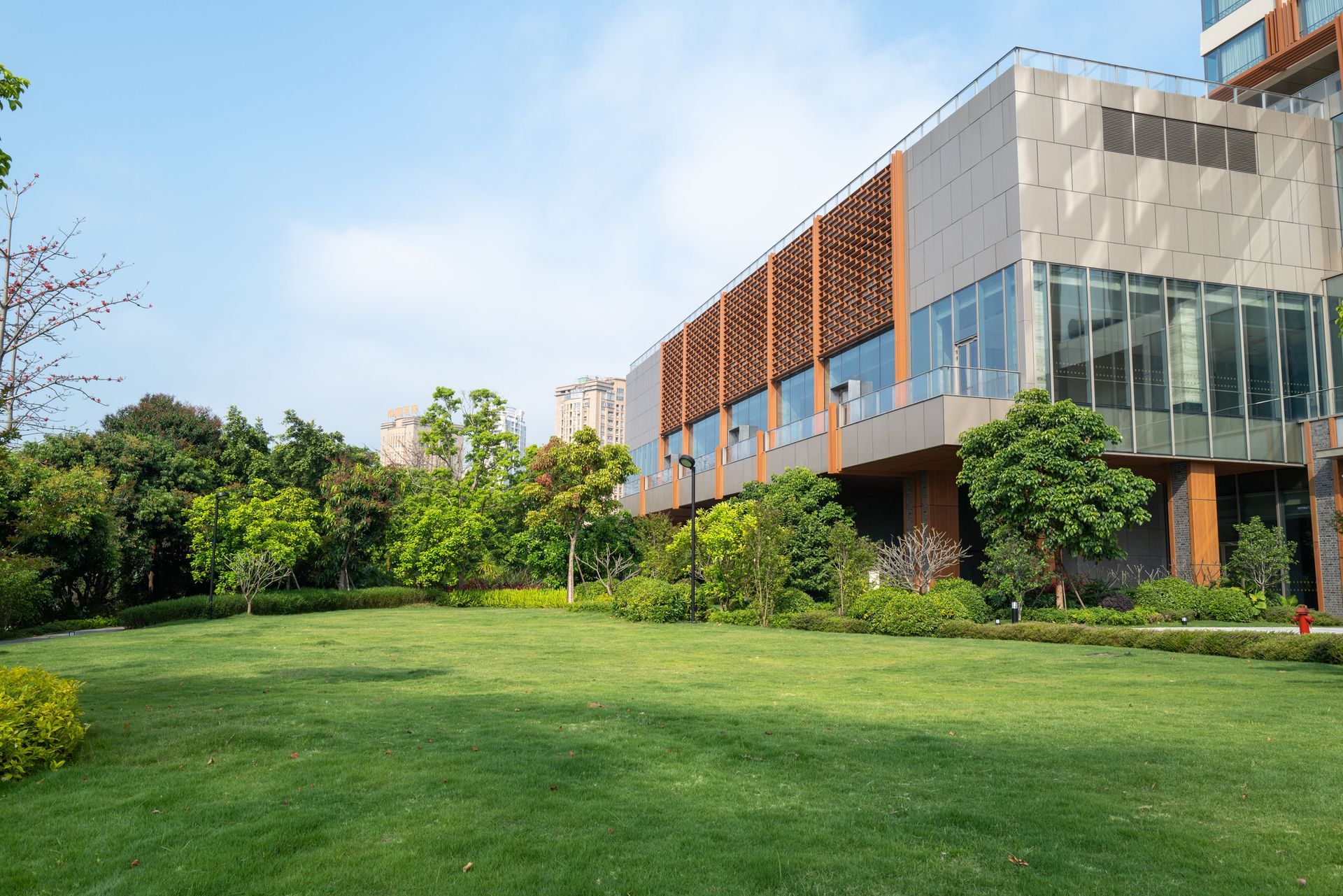 An empty green meadow in front of a modern commercial building. An empty green meadow in front of a modern commercial building.