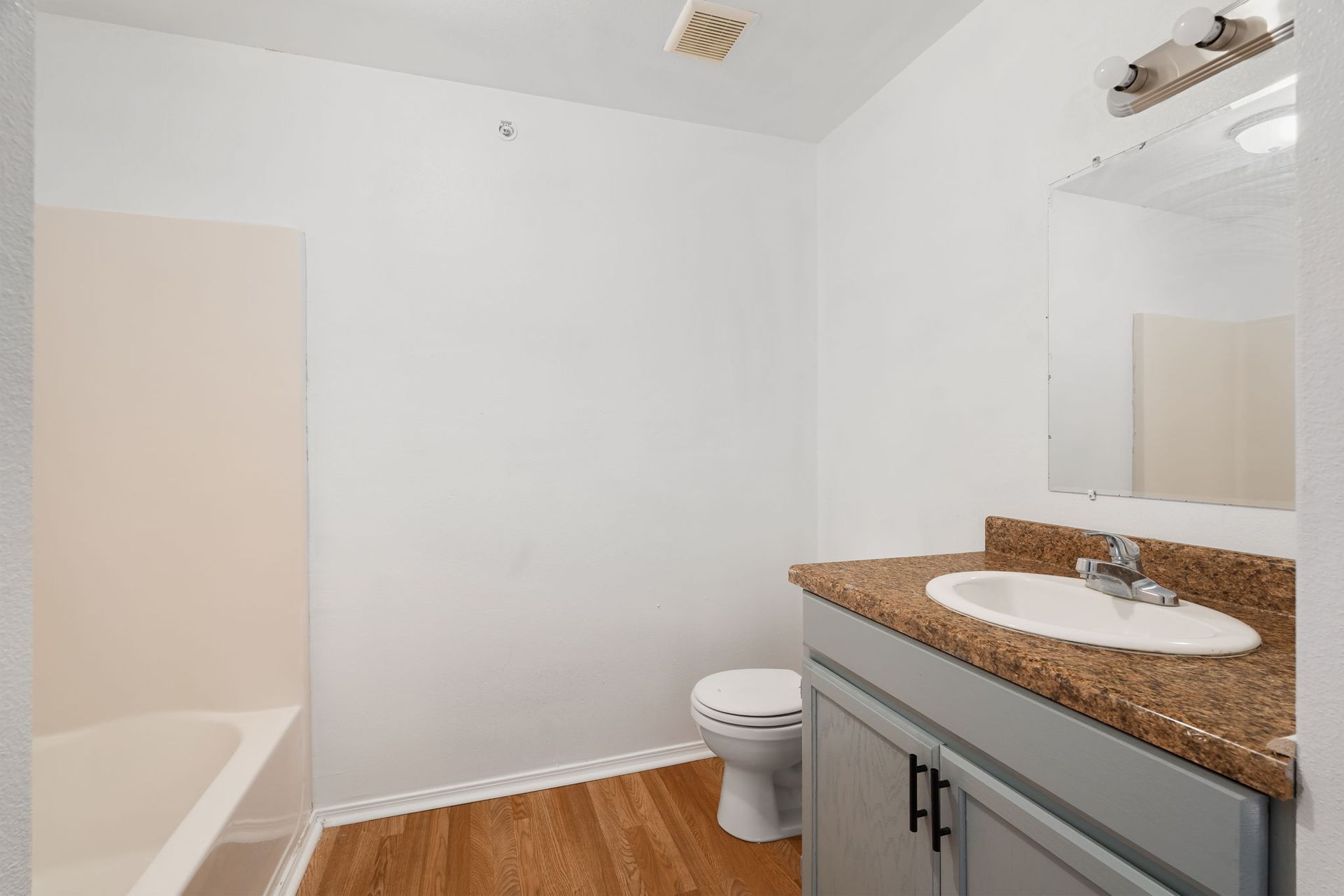 A bathroom with a sink , toilet , and bathtub.