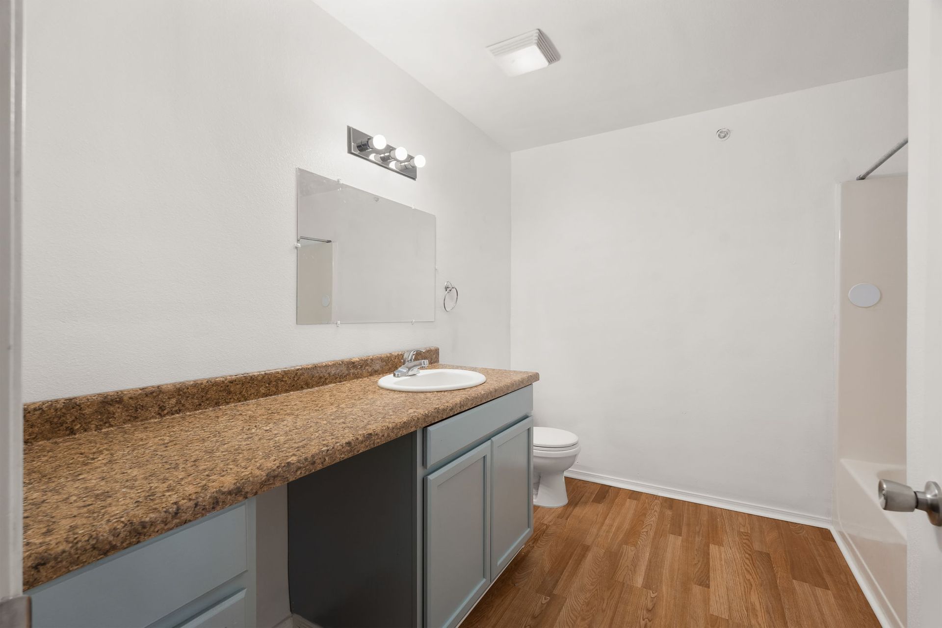 A bathroom with a sink , toilet , and bathtub.