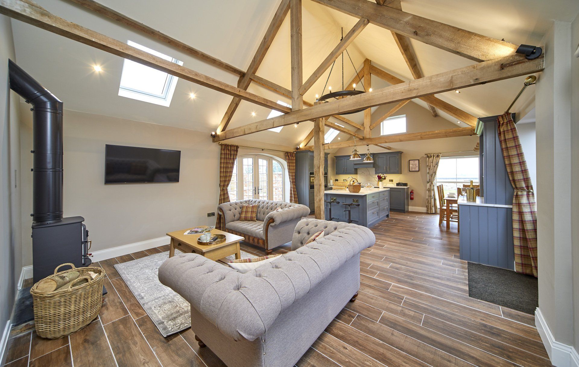 A living room with a couch and a television on the wall.
