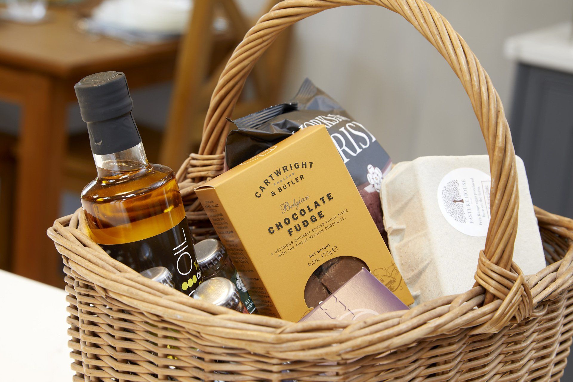 A wicker basket filled with a variety of food and drinks.