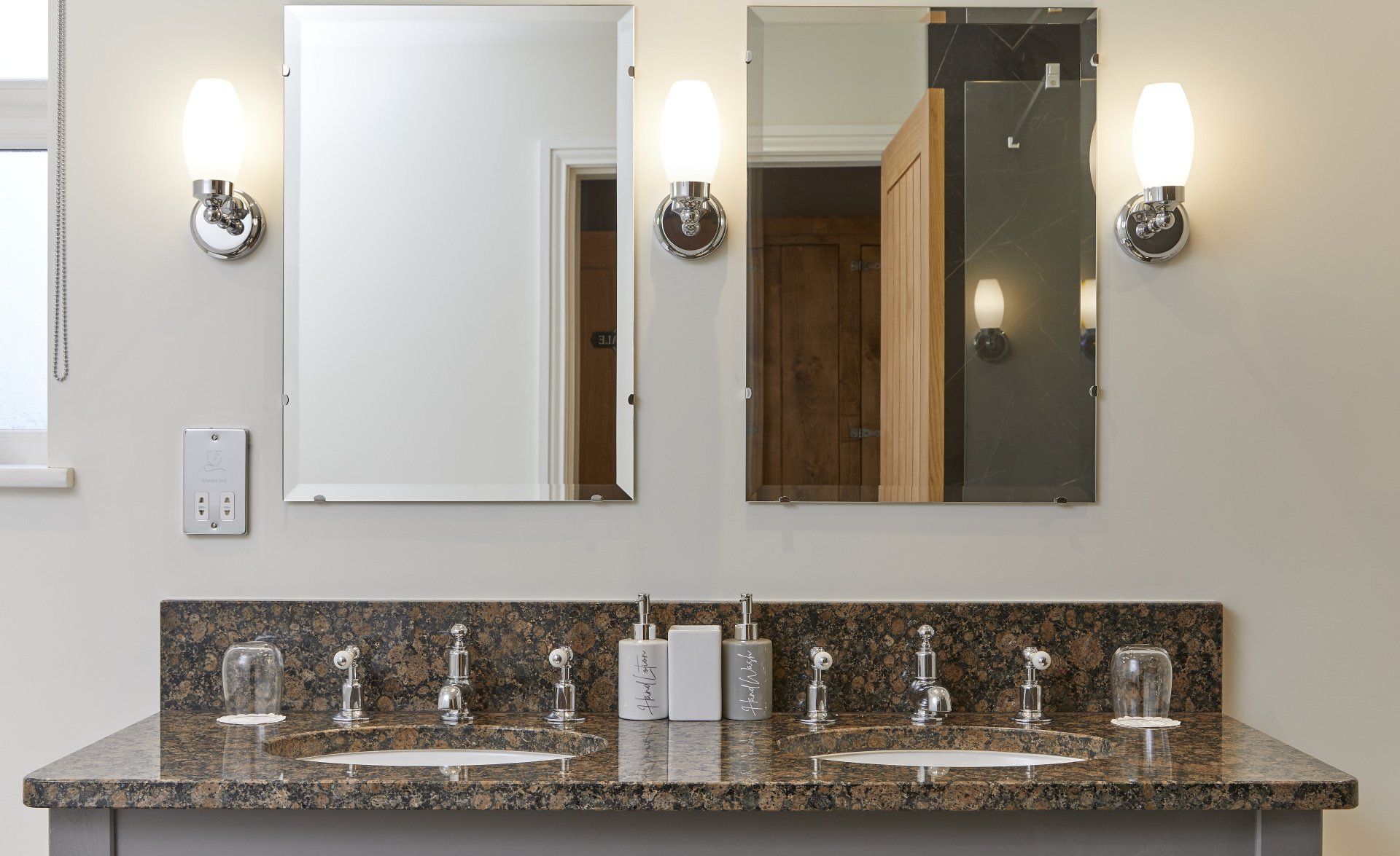 A bathroom with two sinks and two mirrors.