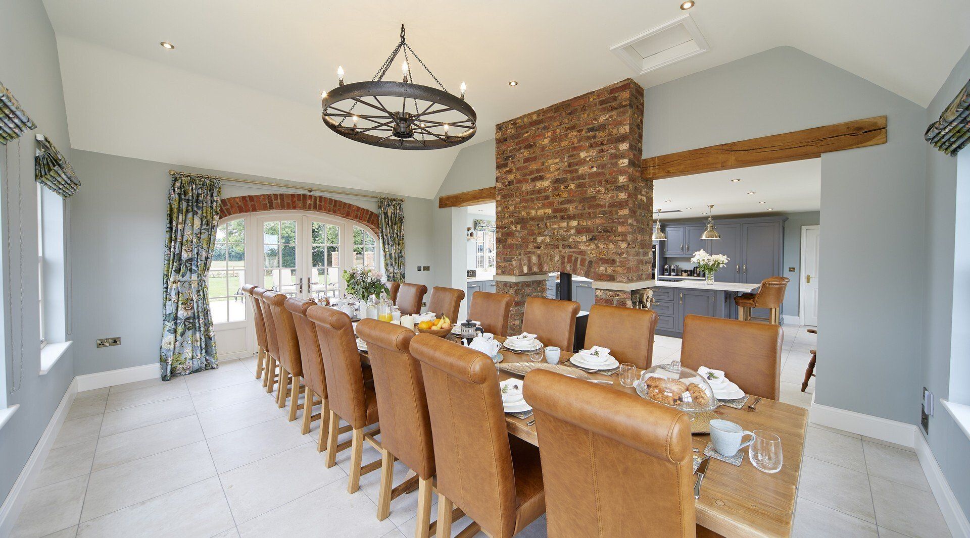 A large dining room with a long table and chairs