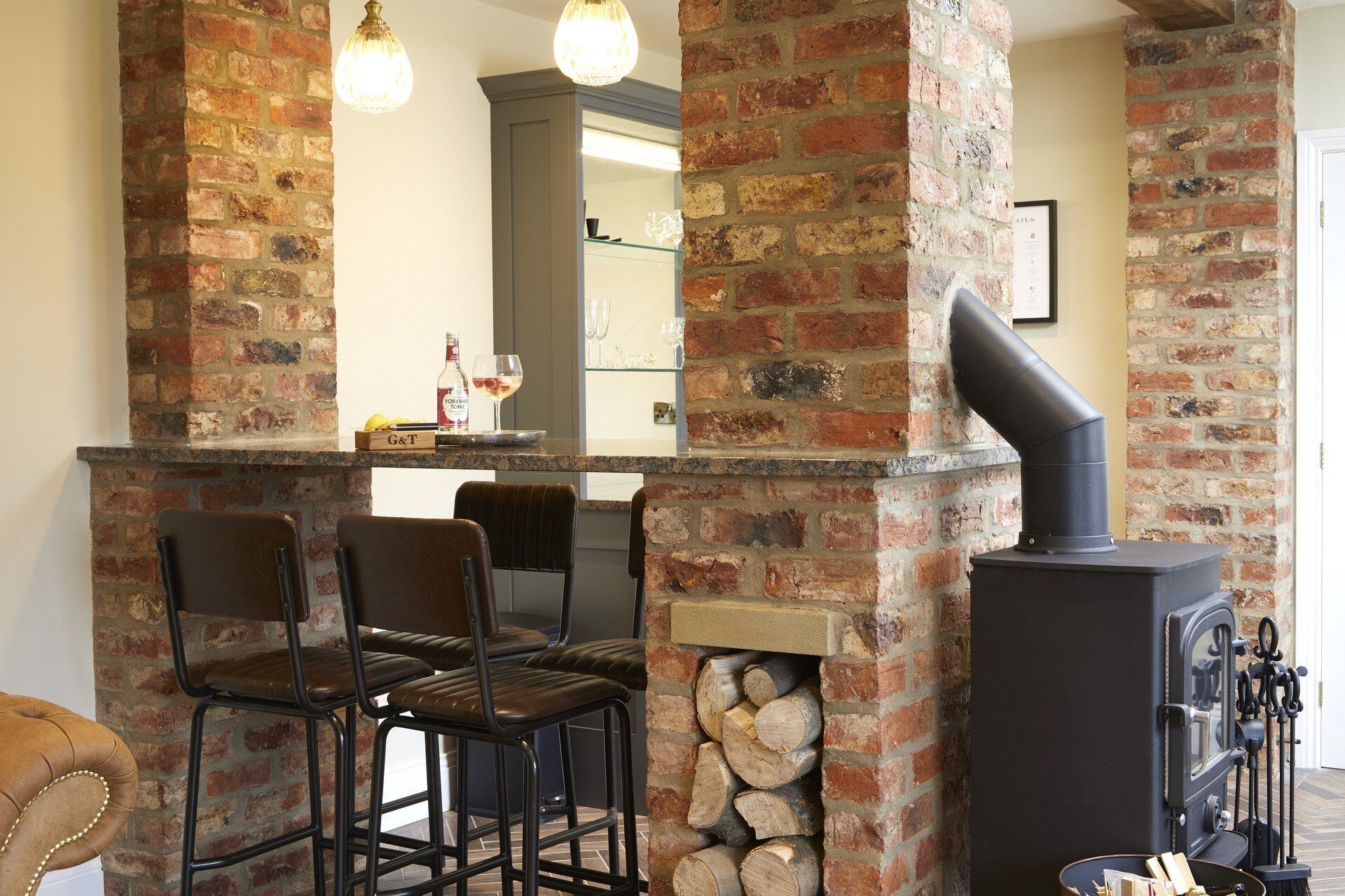A living room with brick columns and a fireplace