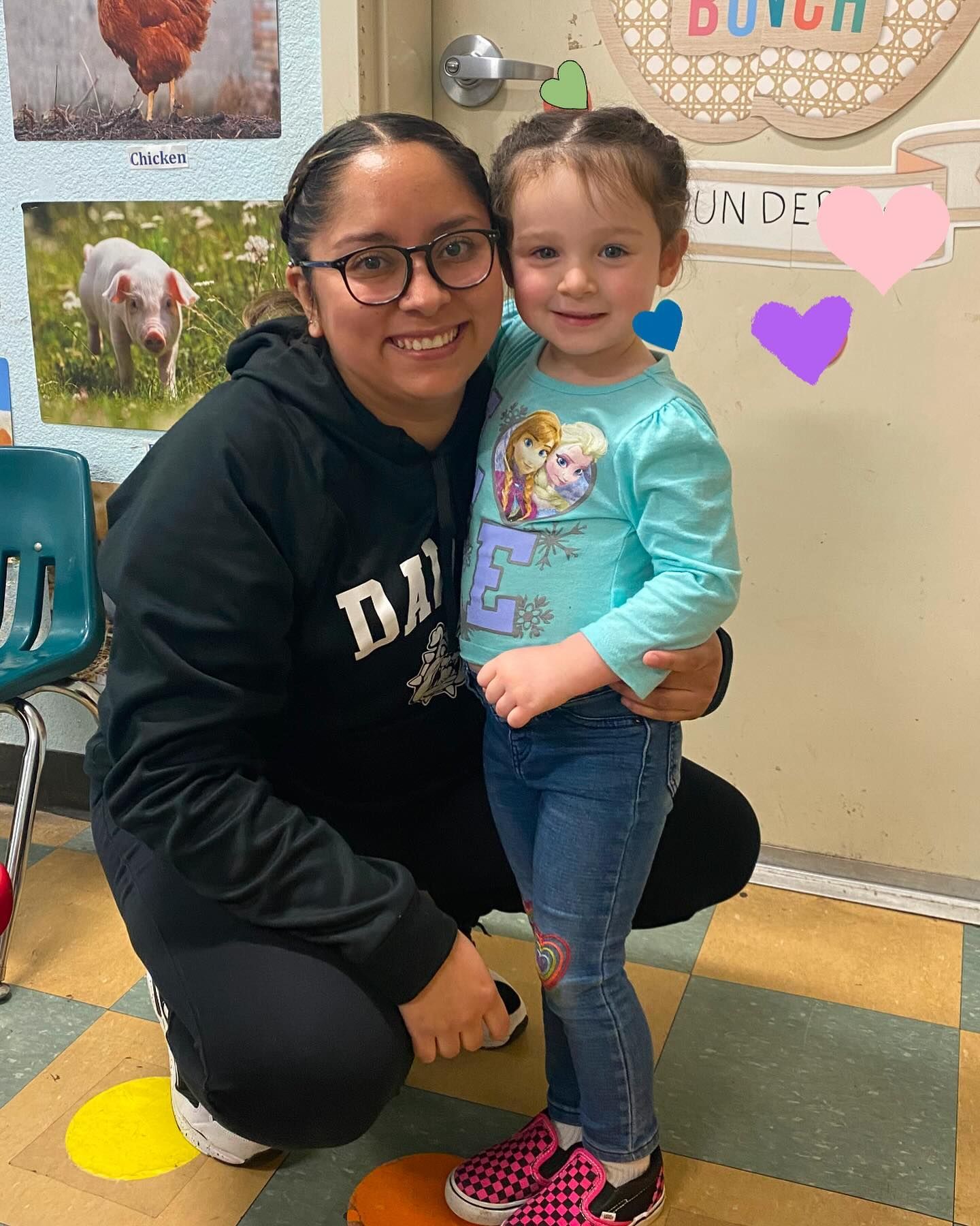 A woman is kneeling down next to a little girl.