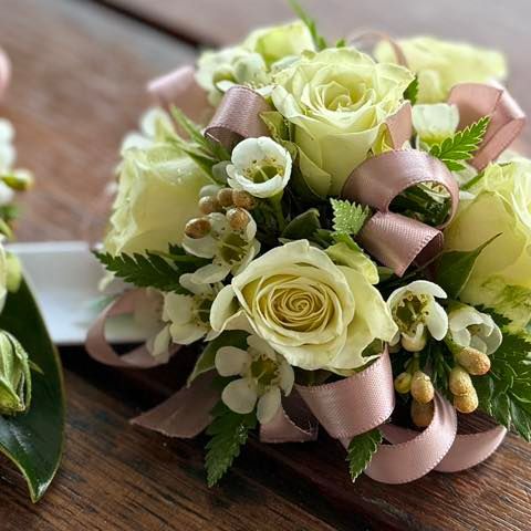 Close-up of a floral corsage with white roses, small white flowers, and a pink ribbon — J'adore Flowers & Gifts Cairns in Earlville, QLD